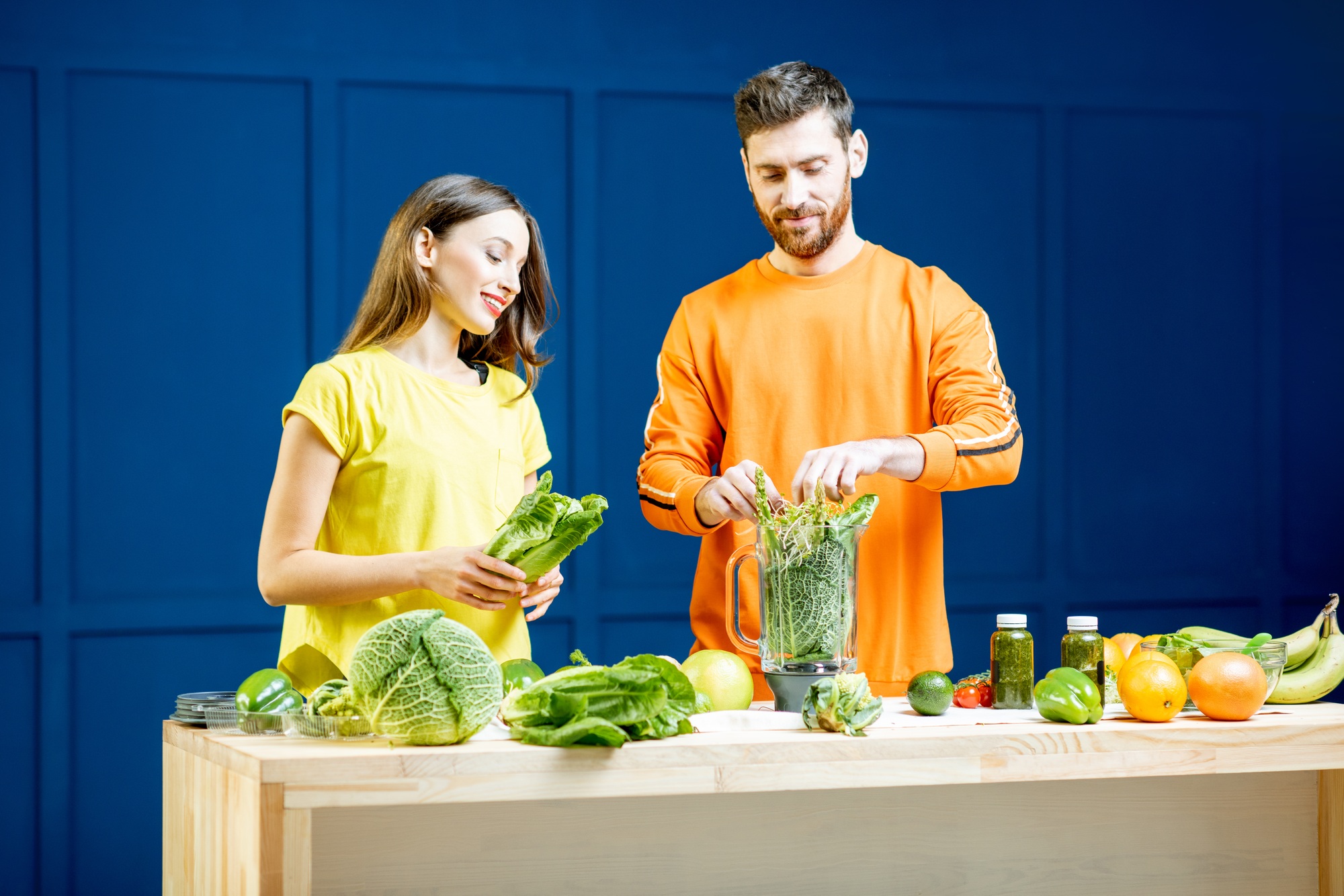 Colorful portrait of a yung couple with healthy food