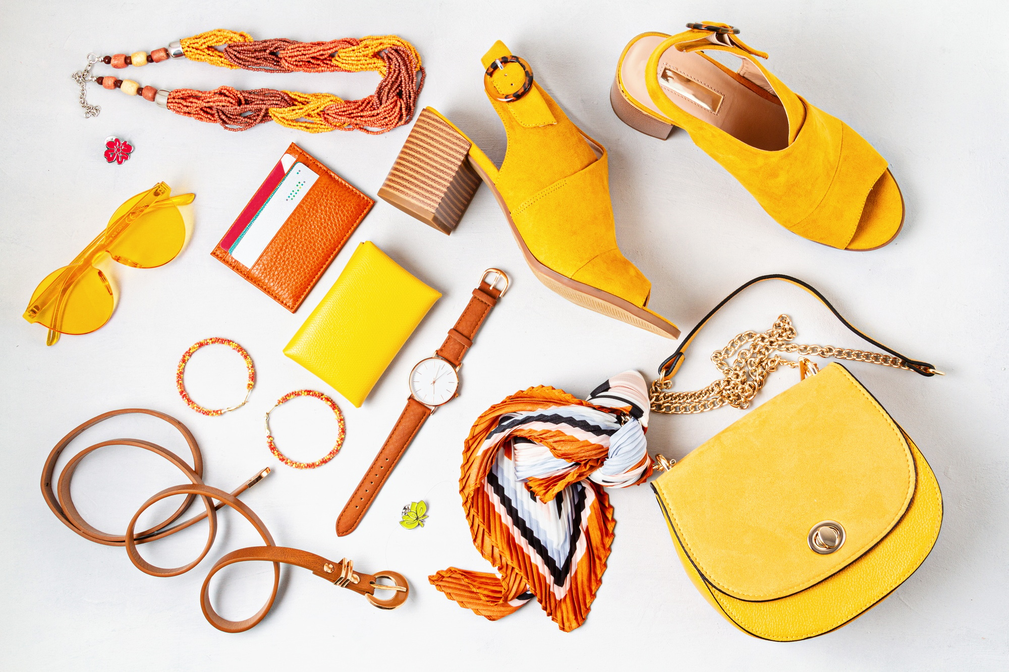 Flat lay with woman fashion accessories in yellow colors