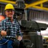 Front view of smart technician or engineer worker with protective helmet stand with confident